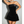 Zwarte strapless mini-jurk, fluwelen stof, elegante avondkleding, vrouw poseert met hand op heup, chique mode, feestjurk.