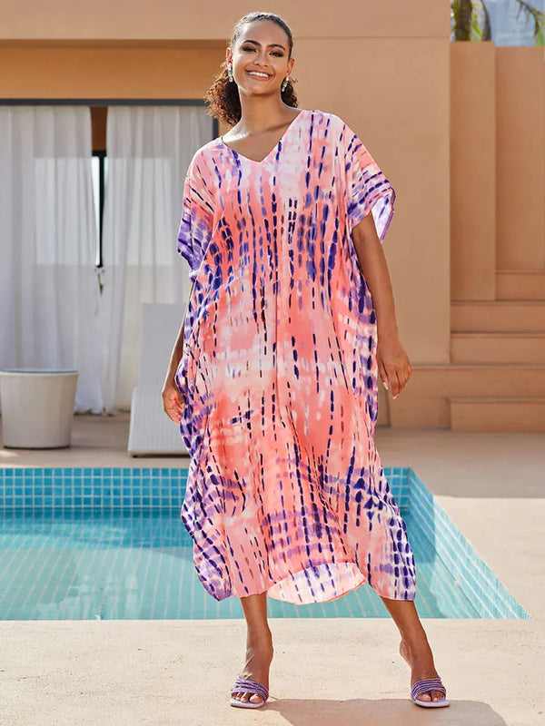 Vrouw in kleurrijke kaftan bij zwembad, zomermode, strandkleding, roze en paarse tie-dye print, ontspannen vakantie sfeer.