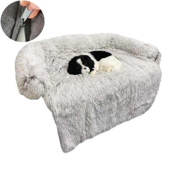 Grijze pluche hondenbank met een slapende zwart-witte hond. Afneembare hoes met rits. Comfortabele huisdierensofa voor kleine honden.