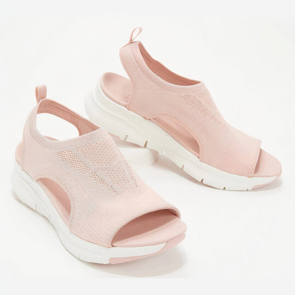 Roze dames sandalen met open teen en dikke witte zool, ademend gebreid bovenwerk. Comfortabele zomerschoenen, modieus en lichtgewicht.