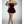Vrouw in strapless bordeauxrode fluwelen jurk, elegante avondkleding, zilveren hakken, modieuze feestjurk, chique uitstraling.