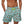 Lichtblauwe zwembroek met ananasprint, gedragen door een man. Trendy herenmode, zomerse stijl, comfortabele pasvorm, strandkleding.