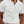 Man in witte geribbelde polo, korte mouwen, casual stijl, zomermode, herenkleding, buiten, beige broek, moderne uitstraling.