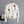 Witte leren jas met bloemenborduursels, zilveren knopen en gespen, hangend aan een hanger. Trendy damesmode, stijlvolle jas, boho-chic.