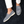 Grijze suède loafers voor heren op donkerblauw tapijt, gedragen met witte broek. Stijlvolle casual schoenen, comfortabele pasvorm.