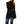 Zwarte damesjas met asymmetrische knopen, gedragen met blauwe jeans en hoge laarzen. Stijlvolle wintermode, trendy dameskleding.