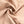 Beige stretchstof close-up, gedrapeerd en geplooid, ideaal voor kleding en modeontwerp. Elastische textieltextuur, naad zichtbaar.
