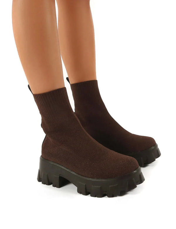 Bruine soklaarzen met dikke zwarte zool, modieuze dameslaarzen, comfortabele stretchstof, trendy herfst- en wintermode, casual en stijlvol.