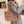 Bruine pluchen schoudertas, gedragen door persoon in grijze jas. Modieuze, zachte handtas voor dames, perfect voor winterse outfits.