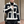 Man in zwart-witte shearling jas, modieuze winterkleding, trendy herenkleding, buitenkleding met contrasterende panelen, stijlvolle jas.