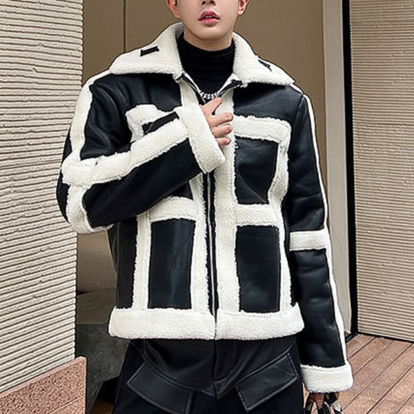 Man in zwart-witte shearling jas, modieuze winterkleding, trendy herenkleding, buitenkleding met contrasterende panelen, stijlvolle jas.