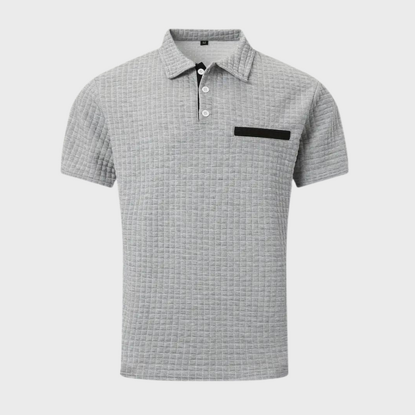 Grijze polo met korte mouwen, geruit patroon en zwarte borstzak. Stijlvolle herenmode, perfect voor casual en zakelijke gelegenheden.