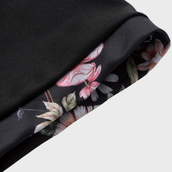 Zwarte sportkleding met bloemenprint detail, ademende stof, stijlvolle en functionele activewear, ideaal voor fitness en outdoor activiteiten.