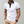 Witte polo met bloemenkraag en mouwdetails, gedragen door man. Stijlvolle herenkleding, casual en trendy, perfect voor zomermode.