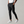 Zwarte chino broek voor heren, stijlvol en modern, gecombineerd met witte sneakers. Perfect voor casual en zakelijke outfits.