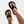 Zwarte leren sandalen met brede band, gedragen aan voeten met witte nagellak en enkelbandje. Stijlvolle zomerschoenen voor dames.