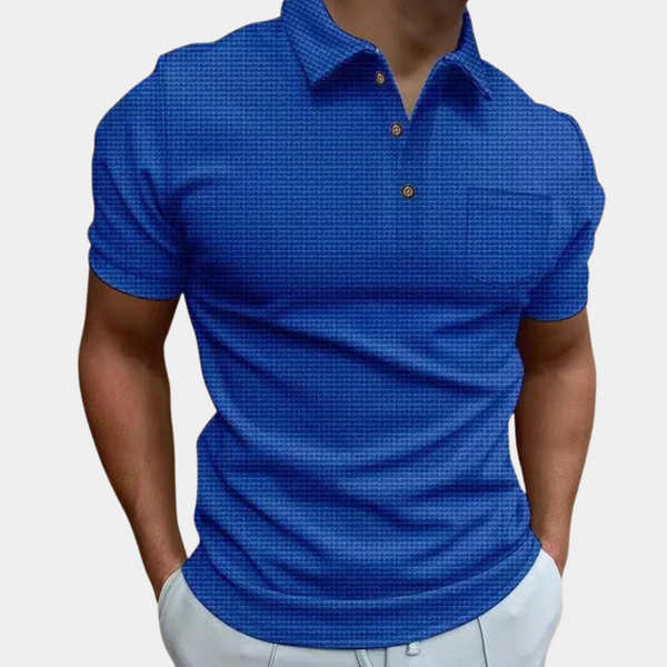 Blauwe herenpolo met korte mouwen, knoopsluiting en subtiel patroon. Perfect voor casual en zakelijke outfits. Comfortabele pasvorm.