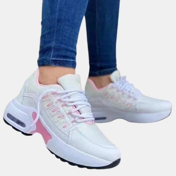 Witte dames sneakers met roze accenten, dikke zool en luchtkussens. Comfortabele sportschoenen, ideaal voor dagelijks gebruik en casual outfits.