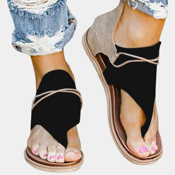 Zwarte sandalen met open teen en gevlochten bandjes, gedragen met gescheurde jeans. Trendy zomerschoenen voor dames, casual en stijlvol.