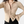 Beige ribgebreide blouse met lange mouwen, knoopsluiting en kraag, gedragen door model. Trendy damesmode, stijlvolle casual outfit.