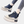Zwarte platform sneakers met dikke zool, ritssluiting en veters, gedragen met gescheurde jeans. Trendy damesschoenen, casual stijl.