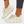 Beige sneakers met uniek golvend zoolontwerp, ademend mesh bovenwerk en vetersluiting. Modieuze en comfortabele schoenen voor dagelijks gebruik.