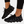 Zwarte futuristische sneakers met golvende zool, gedragen door persoon. Moderne sportschoenen, ademend materiaal, trendy design, comfortabele pasvorm.