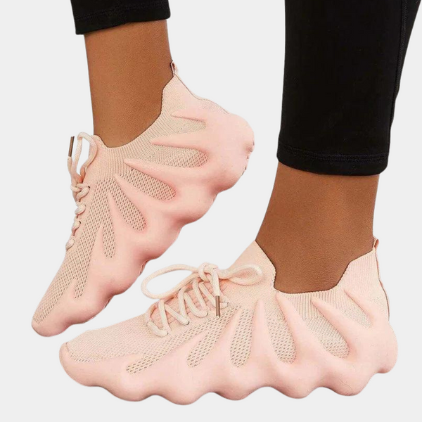 Roze sneakers met golvend zoolontwerp, ademend mesh bovenwerk en vetersluiting. Modieuze damesschoenen, comfortabel en stijlvol.