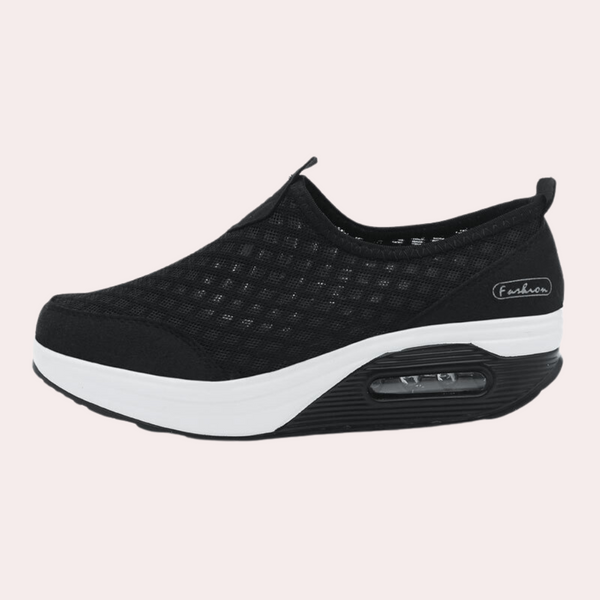 Zwarte dames sneaker met luchtkussen zool, ademend mesh bovenwerk en verhoogde witte zool. Comfortabele en modieuze schoenen voor dagelijks gebruik.