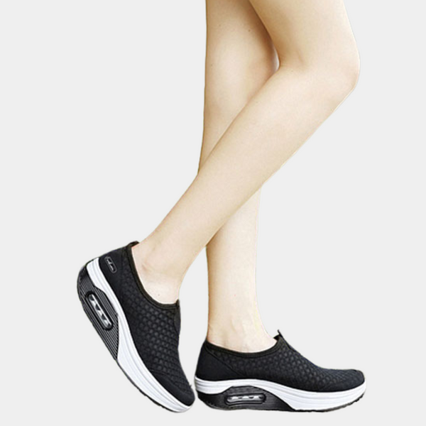 Zwarte dames sneakers met luchtkussen zool, slip-on ontwerp, comfortabele sportieve schoenen, ideaal voor wandelen en dagelijks gebruik.