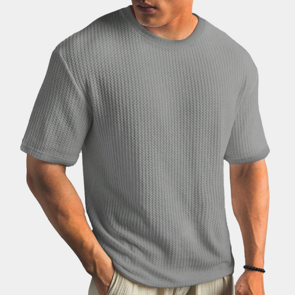 Grijs T-shirt voor heren met textuur, korte mouwen en ronde hals. Comfortabele pasvorm, ideaal voor casual en sportieve outfits.