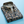 Opgevouwen herenoverhemd met paisleyprint in marineblauw, kleurrijke details en houten knopen, op een lichtblauwe achtergrond.