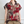 Vrouw draagt een kleurrijke blouse met rood bloemen- en paisleypatroon, korte mouwen en kraag. Modieuze dameskleding, casual stijl.