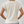 Witte damesblouse met korte mouwen, gemaakt van zachte stof, gedragen door model. Perfect voor casual en zakelijke outfits.
