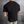 Zwarte heren T-shirt met textuur, gedragen door een man, tegen een metalen achtergrond. Stijlvol en modern design, perfect voor casual outfits.