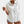 Witte damesblouse met korte mouwen, knoopsluiting en borstzakken, gedragen met denim shorts. Perfect voor casual zomeroutfits.