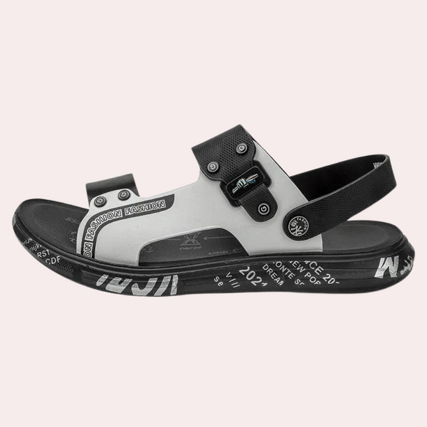Zwart-witte herensandaal met verstelbare bandjes en grafische tekst op de zool. Modieuze zomerschoen, ideaal voor casual en sportieve outfits.