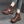 Bruine leren sandalen met dikke zool, open teen en perforaties, gedragen door model in jeans. Trendy damesmode, comfortabele zomerschoenen.