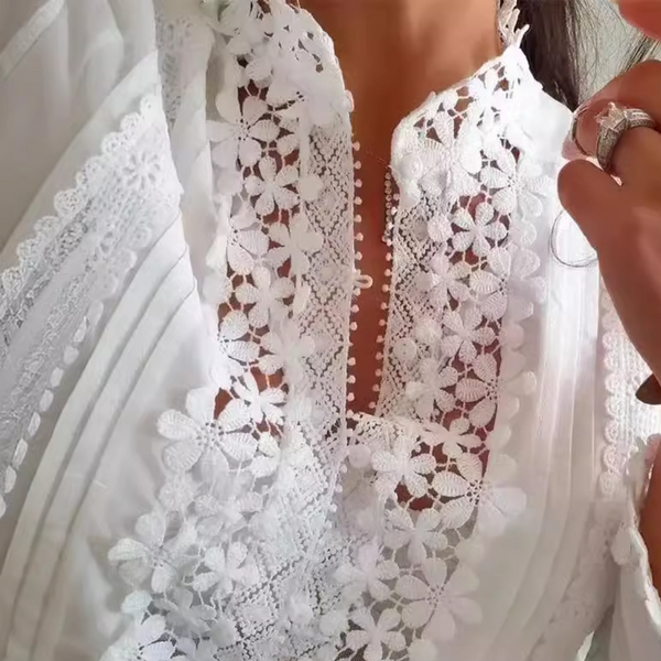Witte kanten blouse met bloemenpatroon, elegante damesmode, close-up van delicate details, stijlvolle kleding voor speciale gelegenheden.