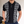 Zwarte polo met witte geometrische patronen, korte mouwen en knoopsluiting. Stijlvolle herenkleding, perfect voor casual en formele gelegenheden.
