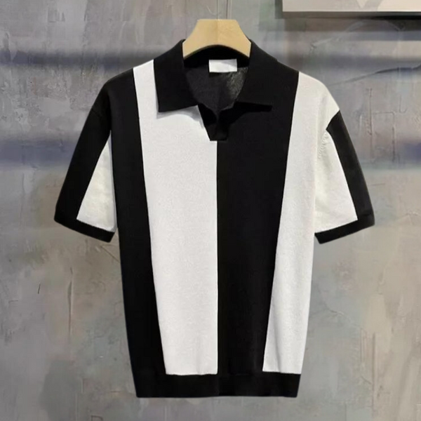 Zwart-wit gestreept poloshirt, korte mouwen, op houten hanger tegen grijze muur. Modieuze herenkleding, casual stijl, contrast design.