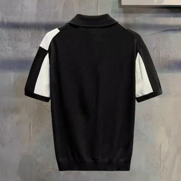 Zwarte polo met korte mouwen en witte accenten, moderne herenkleding, stijlvolle casual outfit, hoogwaardige stof, trendy design.