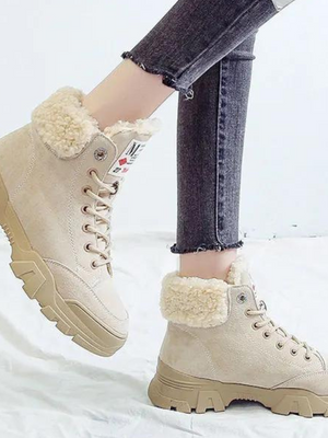 Beige suède laarzen met dikke zool en warme voering, gedragen met donkere jeans. Modieuze winterlaarzen voor dames, ideaal voor koude seizoenen.