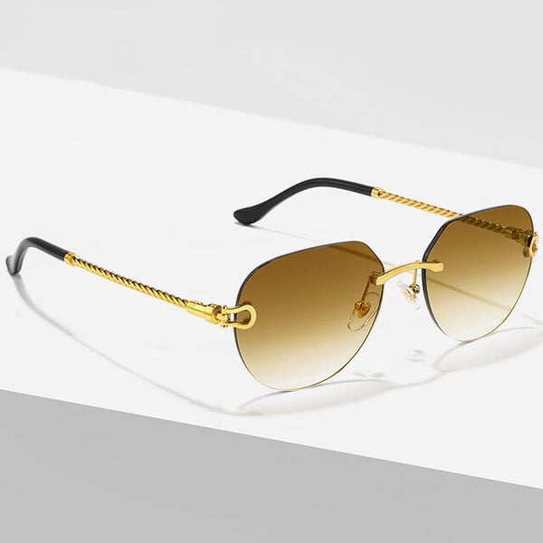Luxe designer zonnebril met goudkleurig metalen montuur en bruin-gradiënt lenzen, geschikt voor mannen en vrouwen. Randloos en stijlvol ontwerp.