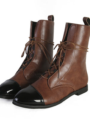 Bruine leren veterlaarzen met zwarte glanzende neuzen, stijlvolle damesmode, comfortabele en duurzame schoenen voor dagelijks gebruik.