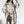 Vrouw in geruite jas en hoed met designer rugzak, modieuze winterlook, stijlvolle dameskleding, trendy accessoires, witte achtergrond.
