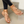 Gouden sandalen met strass, gedragen door vrouw met witte nagellak. Trendy zomerschoenen, perfect voor casual en elegante outfits.
