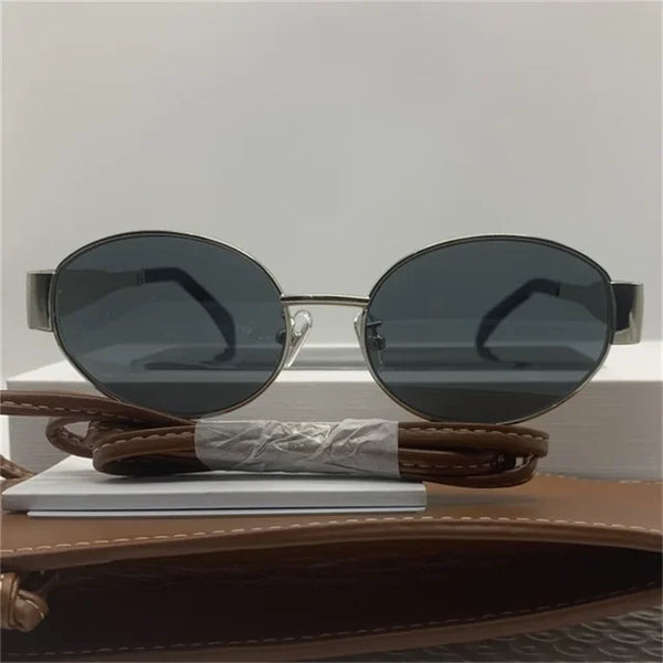 Ovale zonnebril met gouden metalen frame, unisex design, UV400 bescherming, esthetisch merk, geschikt voor zomer, modieuze accessoire.