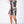 Man in modieuze, zwart-witte barokprint set met korte mouwen en shorts, poseert tegen witte achtergrond. Trendy herenmode, zomeroutfit.