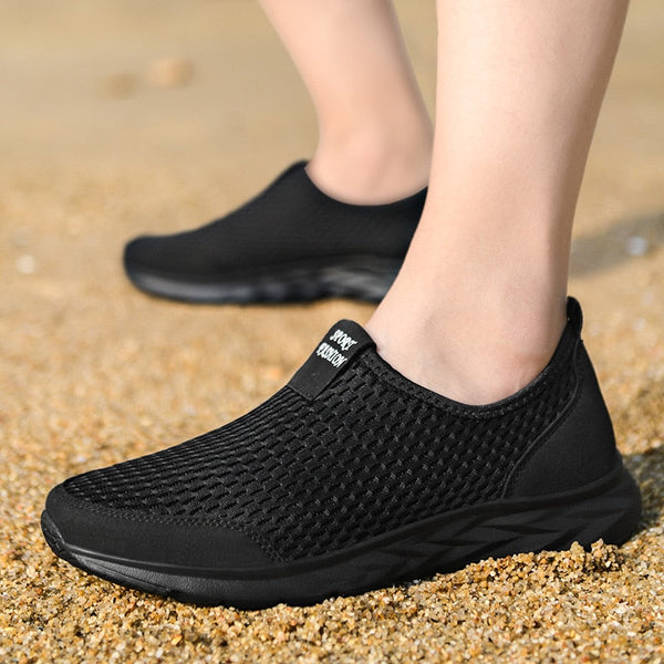 Zwarte ademende wandelschoenen voor dames op grindpad, lichtgewicht en comfortabel, ideaal voor buitenactiviteiten en dagelijks gebruik.